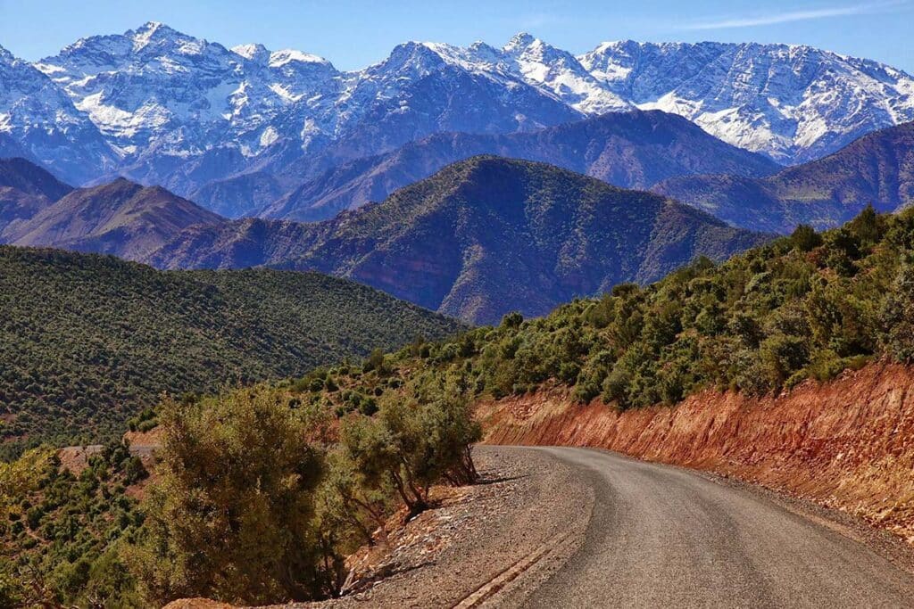 Mountain road winding through lush foothills toward Atlas peaks