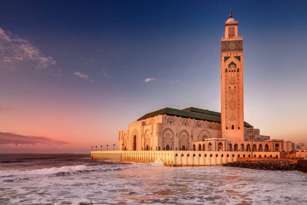 Hassan II Mosque glowing at sunset on Casablanca seafront