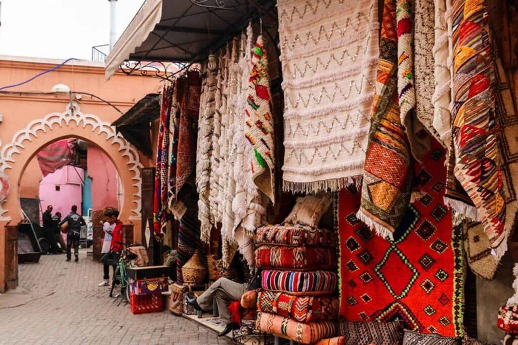 Colorful Moroccan rugs hanging in a souk in the Medina of Marrakech.