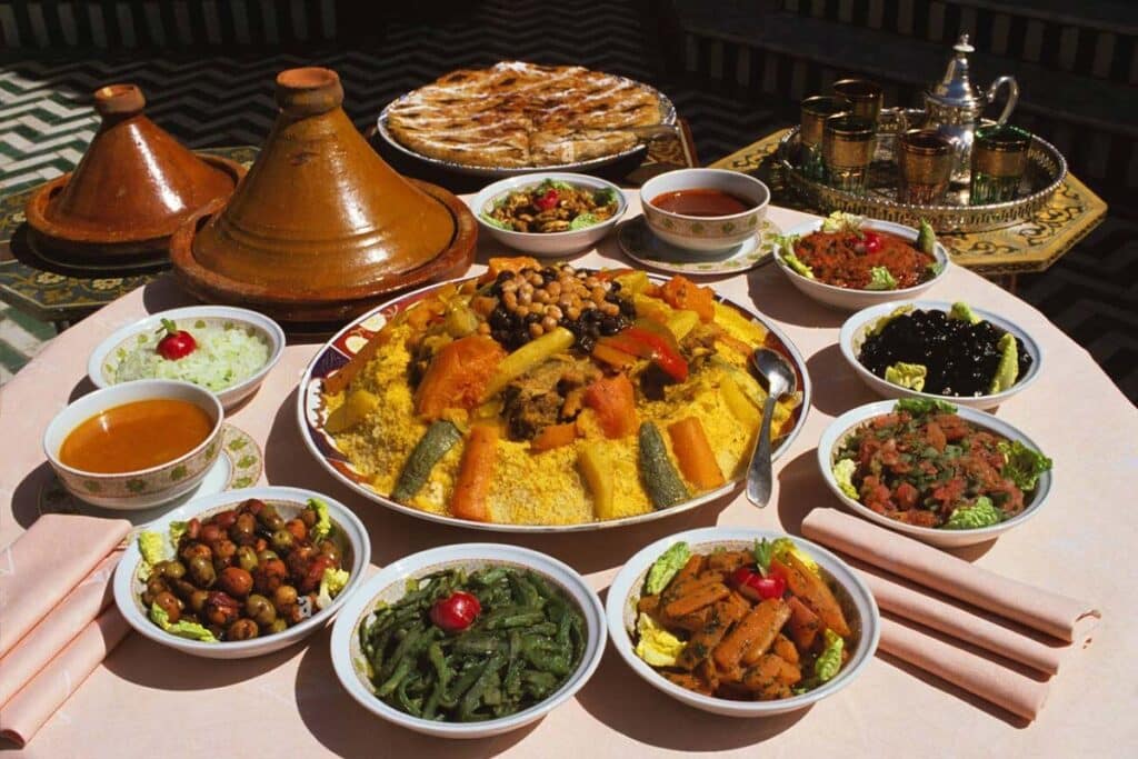 Traditional Moroccan couscous and tagine dishes served with assorted salads and mint tea.